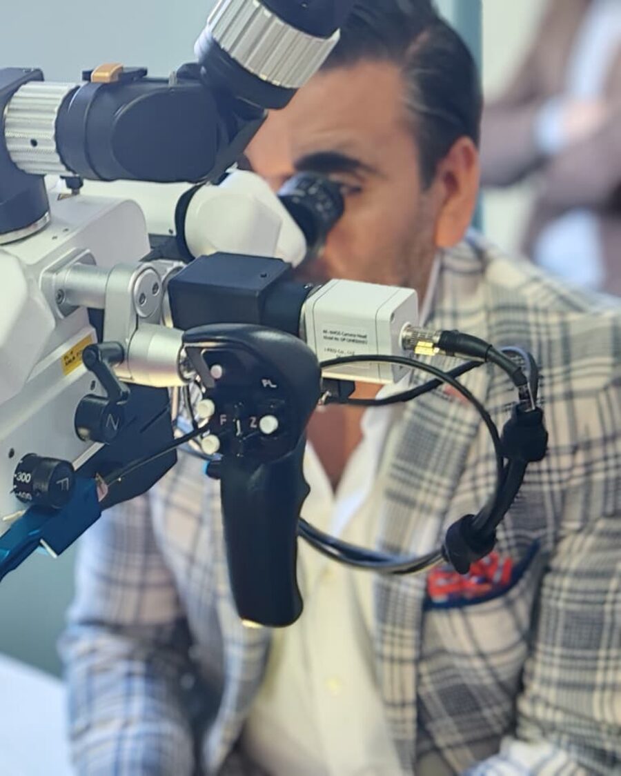 Dr. Ramirez performing microsurgery under an operating microscope